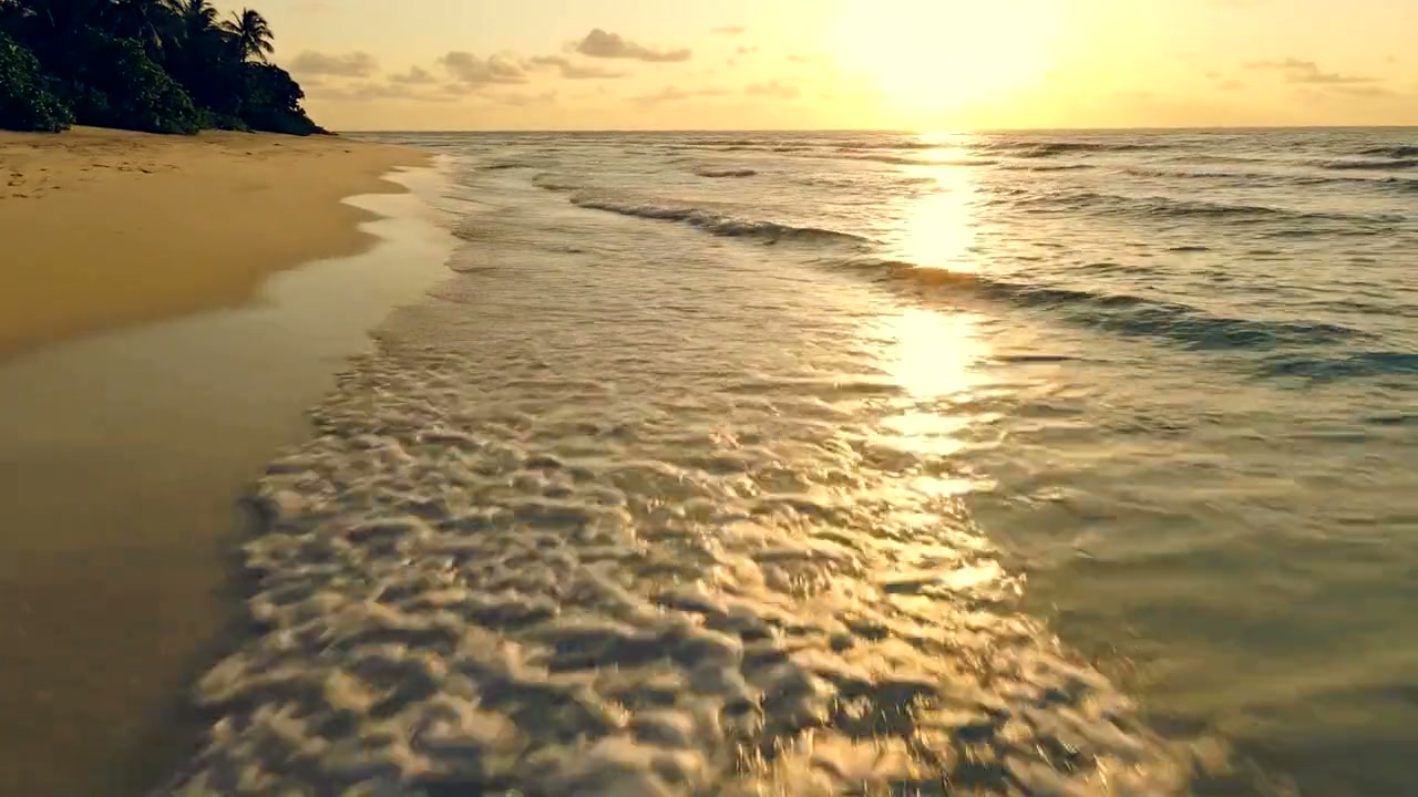 The same shoreline with the sea pushed teal and the sunset and sand pushed orange