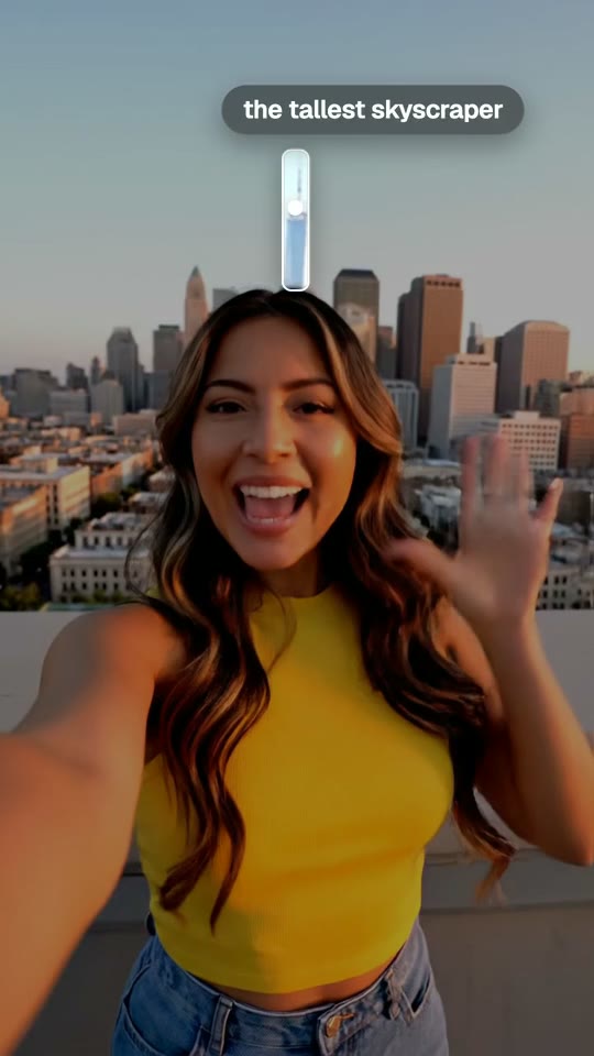 Find in Frame boxing the tallest skyscraper behind a vlogger on a rooftop
